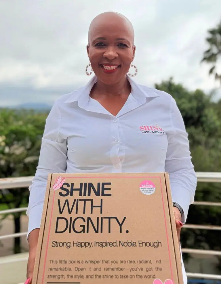 Maggie Molotsi holding a SHINE With Dignity box
